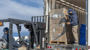 movers using a forklift for heavy boxes