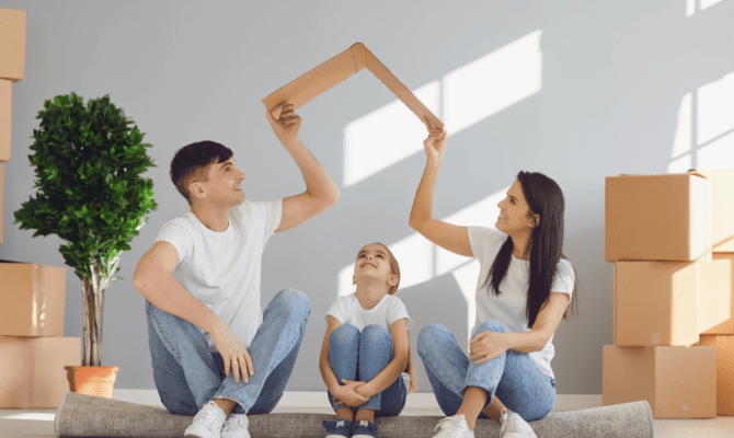 young couple and daughter taking a fun break on moving day